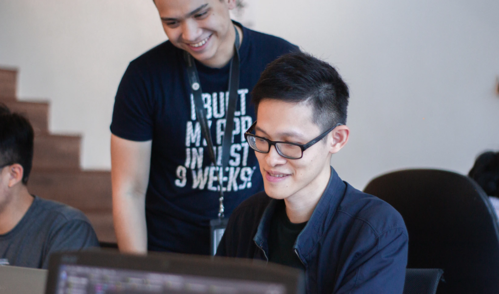 mentee and mentor, two students looking at screen