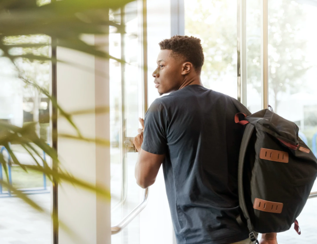 services at york university, student walking out glass door