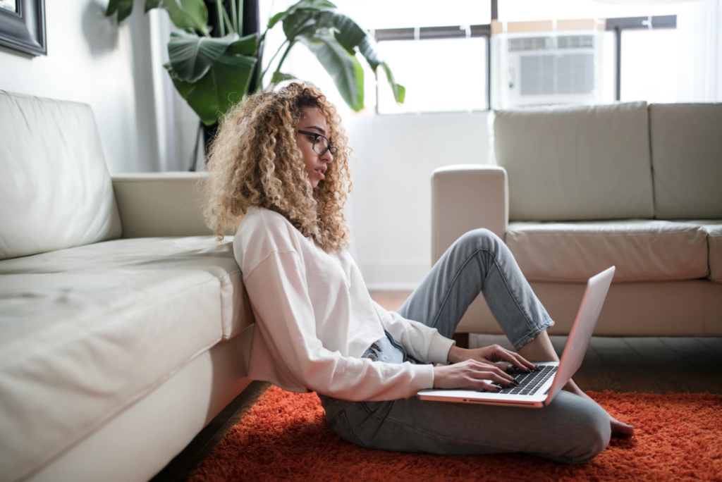 simon fraser university's academic services, student sitting on floor with laptop