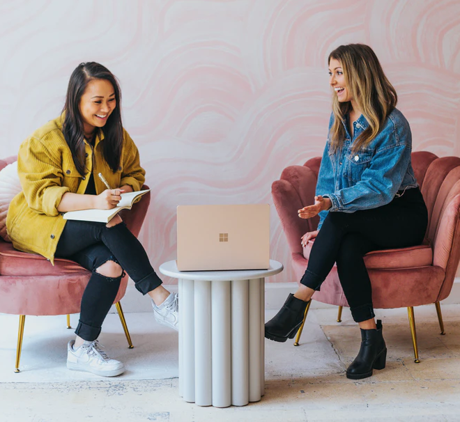 interview prep two students on chairs with laptop