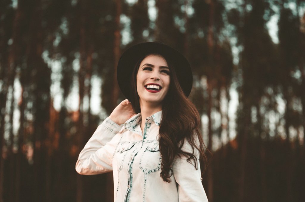 summer jobs woman wearing hat smiling outdoors