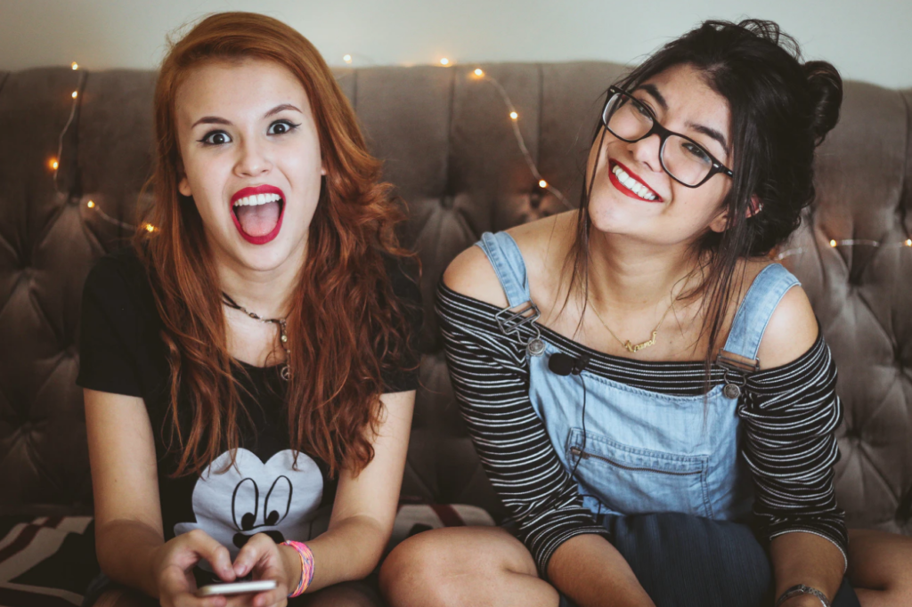 university of alberta events two girls smiling on sofa