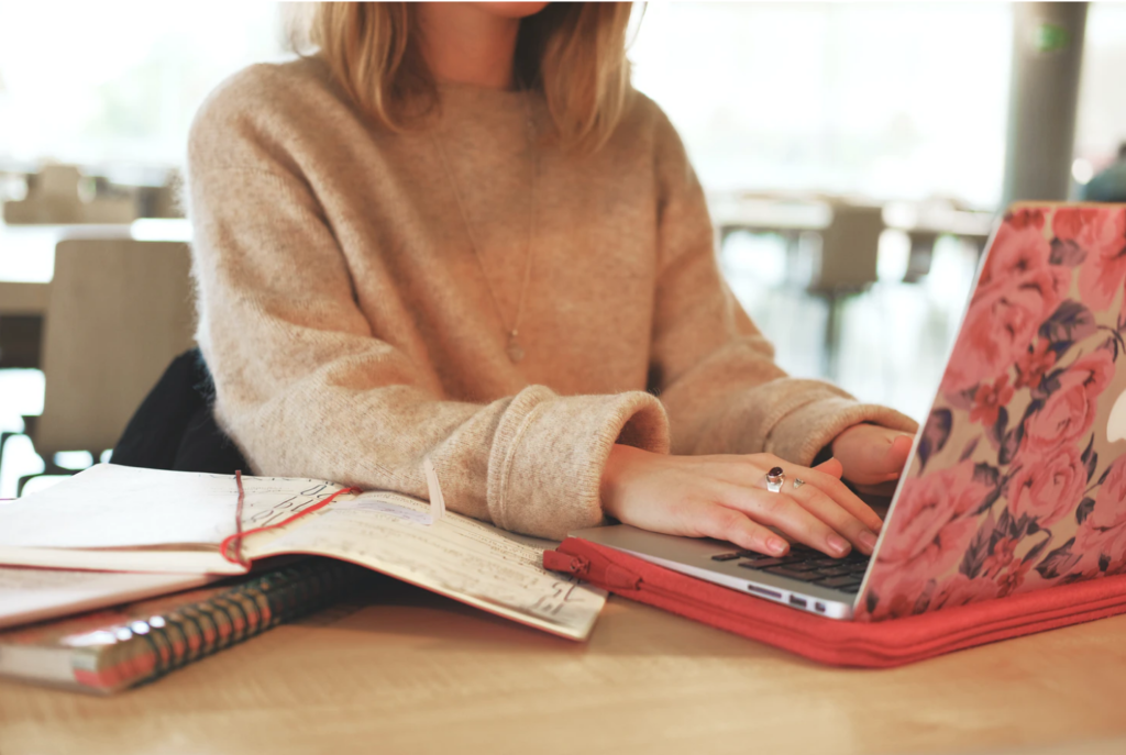 student resources woman tying on laptop with roses skin