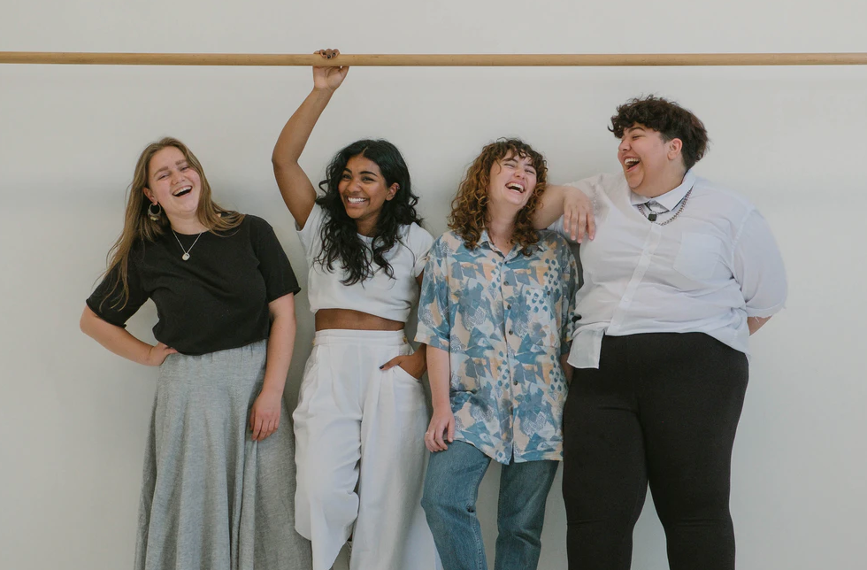 student traditions group of students laughing and leaning against a wall