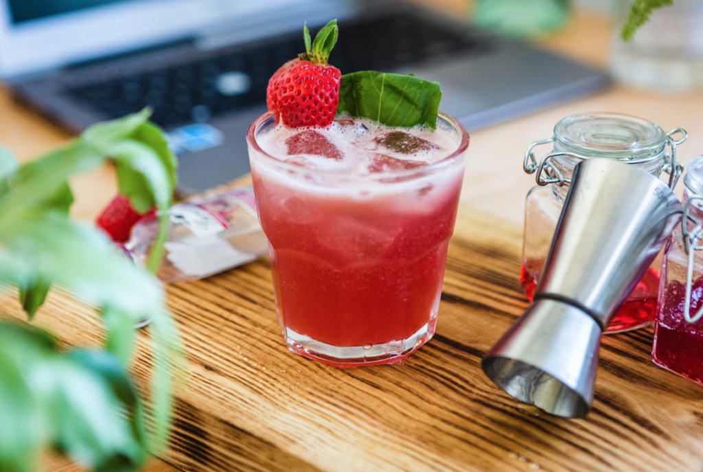 drinks at st. francis xavier university , red cocktail on wooden cutting board