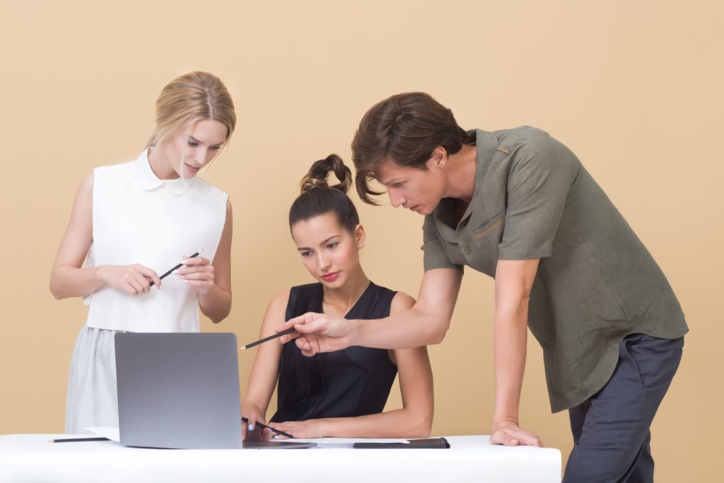 services at trent university three students looking at laptop screen