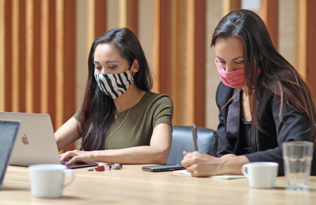 two female students wearing masks taking notes, services at cambrian college