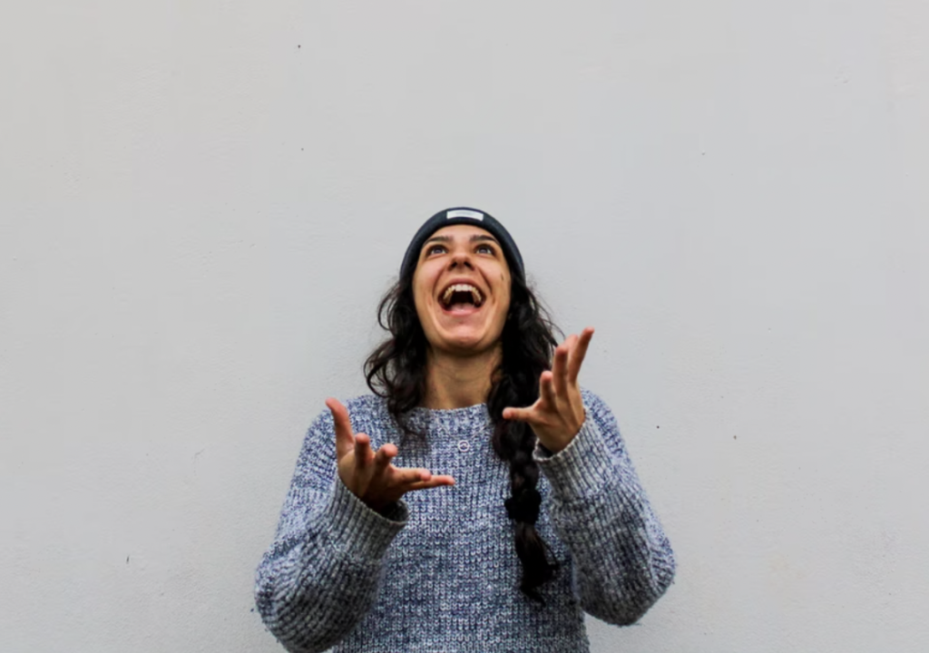 woman looking up with raised hands and smiling, money matters at laurentian university