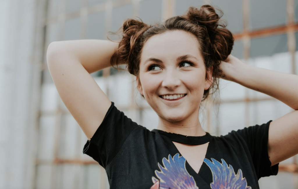 girl smiling to the side with hands behind her head, money matters at trent university